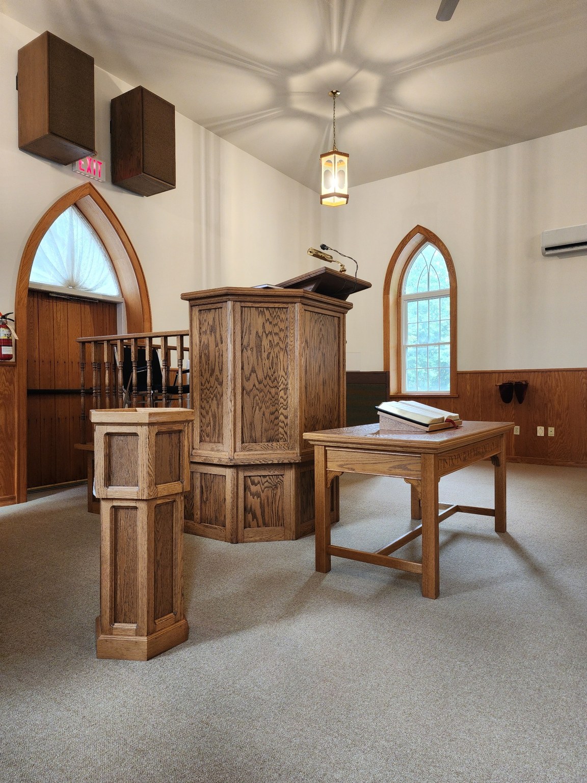 Pulpit, baptismal font, communion table, and open Bible in the Salem sanctuary